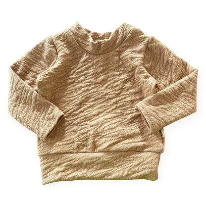 Beige textured sweater on a white background
