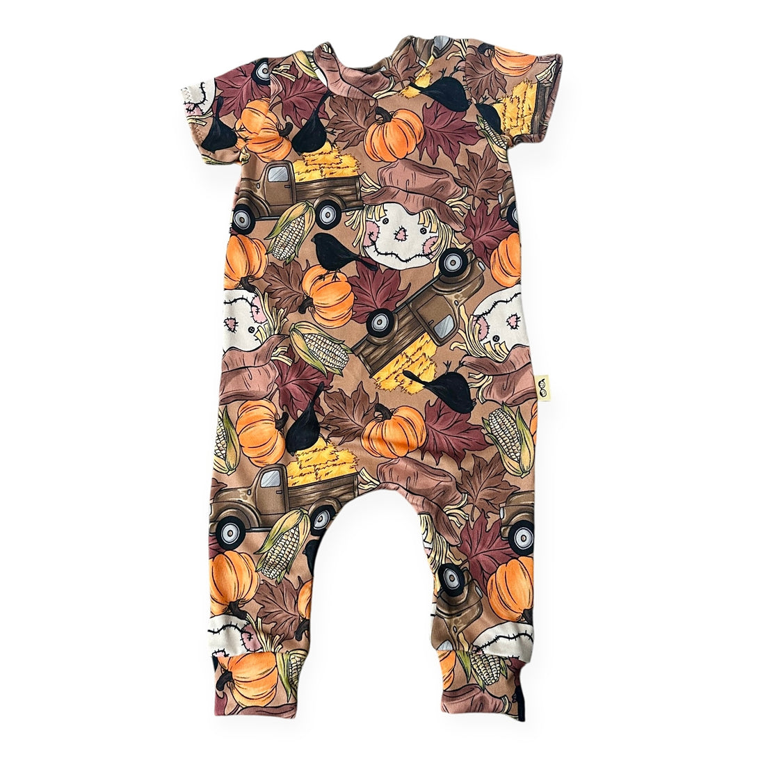 Halloween-themed baby romper with pumpkins, ghosts, and corn on a white background