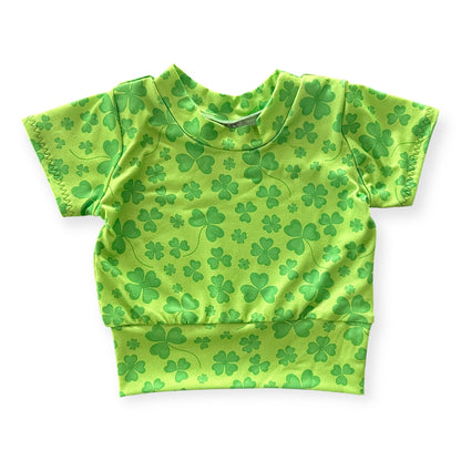 Green shamrock baby t-shirt with a cozy waistband, perfect for St. Patrick’s Day or festive everyday wear. Handmade with soft, stretchy fabric for newborns, infants, and toddlers. A lightweight, short-sleeve design for ultimate comfort and style.