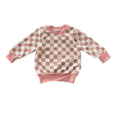 Angled view of mauve checker smiley icons baby sweatshirt.