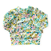 Floral patterned baby top on a white background