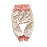 Blush pink baby lounge pants with checker and smiley face print, ribbed waistband.