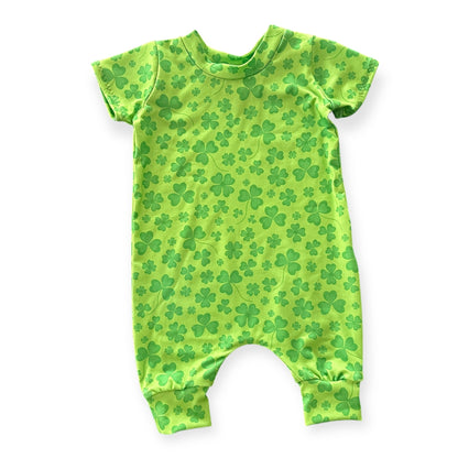 Bright green shamrock baby romper, available in long sleeve, sleeveless, and short sleeve options. Perfect for St. Patrick’s Day celebrations, this handmade outfit offers comfort and style for newborns, infants, and toddlers. Ideal for festive family photos or holiday outfits