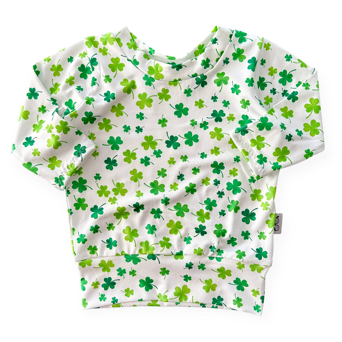 Handmade white lounge top with green shamrock print for babies and toddlers. Perfect for St. Patrick&