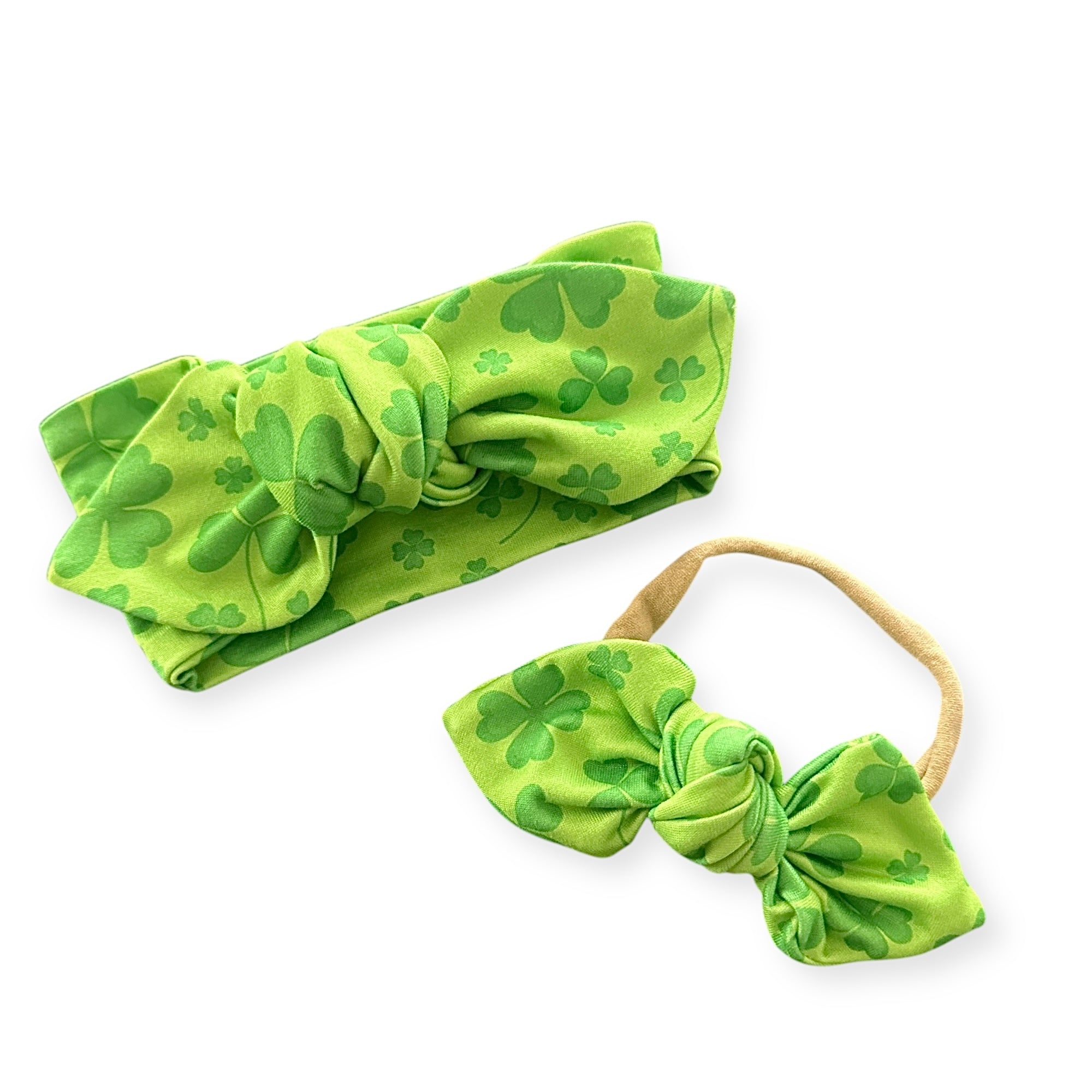 &quot;reen shamrock baby headband set featuring a wide bow headband and a stretchy elastic bow, perfect for St. Patrick’s Day outfits or festive photo shoots. Handmade baby accessories with soft, comfortable fabric for newborns, infants, and toddlers.