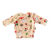 Retro-style Christmas ribbed baby top with Santa, reindeer, and wreath print – handmade holiday outfit.