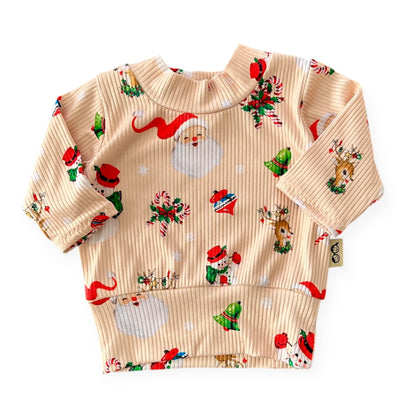 Retro-style Christmas ribbed baby top with Santa, reindeer, and wreath print – handmade holiday outfit.