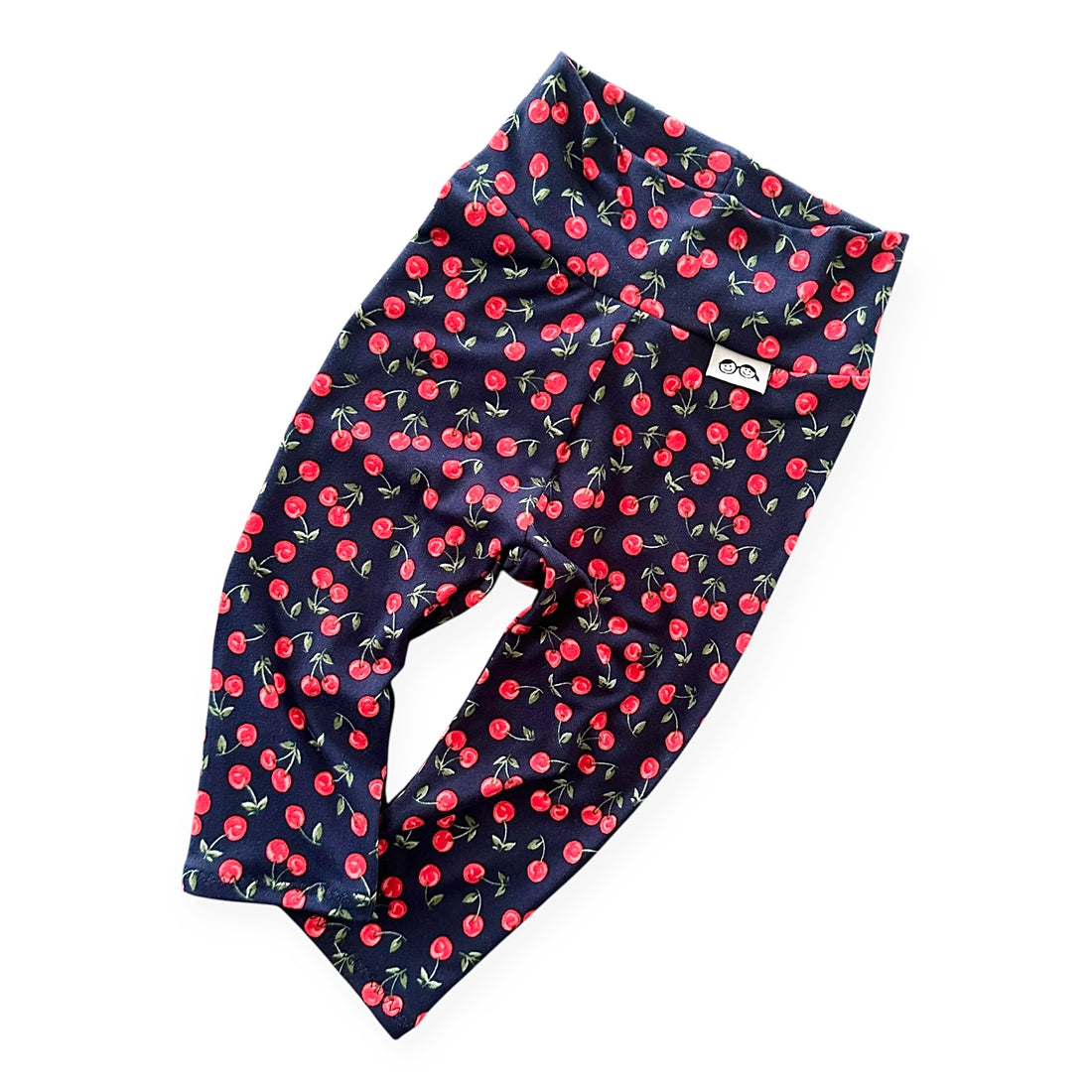 Midnight Cherries baby leggings in a dark navy cherry pattern, designed for a cozy and stylish fit. Handmade with premium stretchy knit fabric.