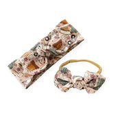 Handmade baby headbands in Campfire & S’mores Adventures print with campers and trees.