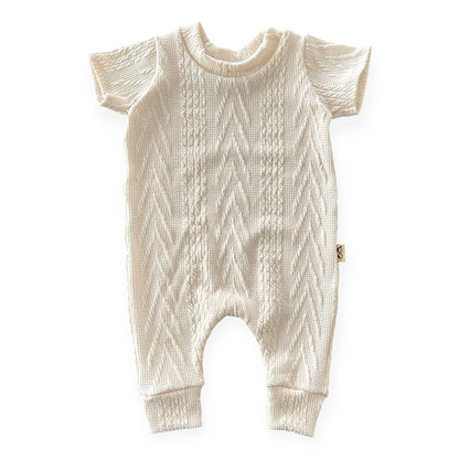 Knitted baby romper on a white background