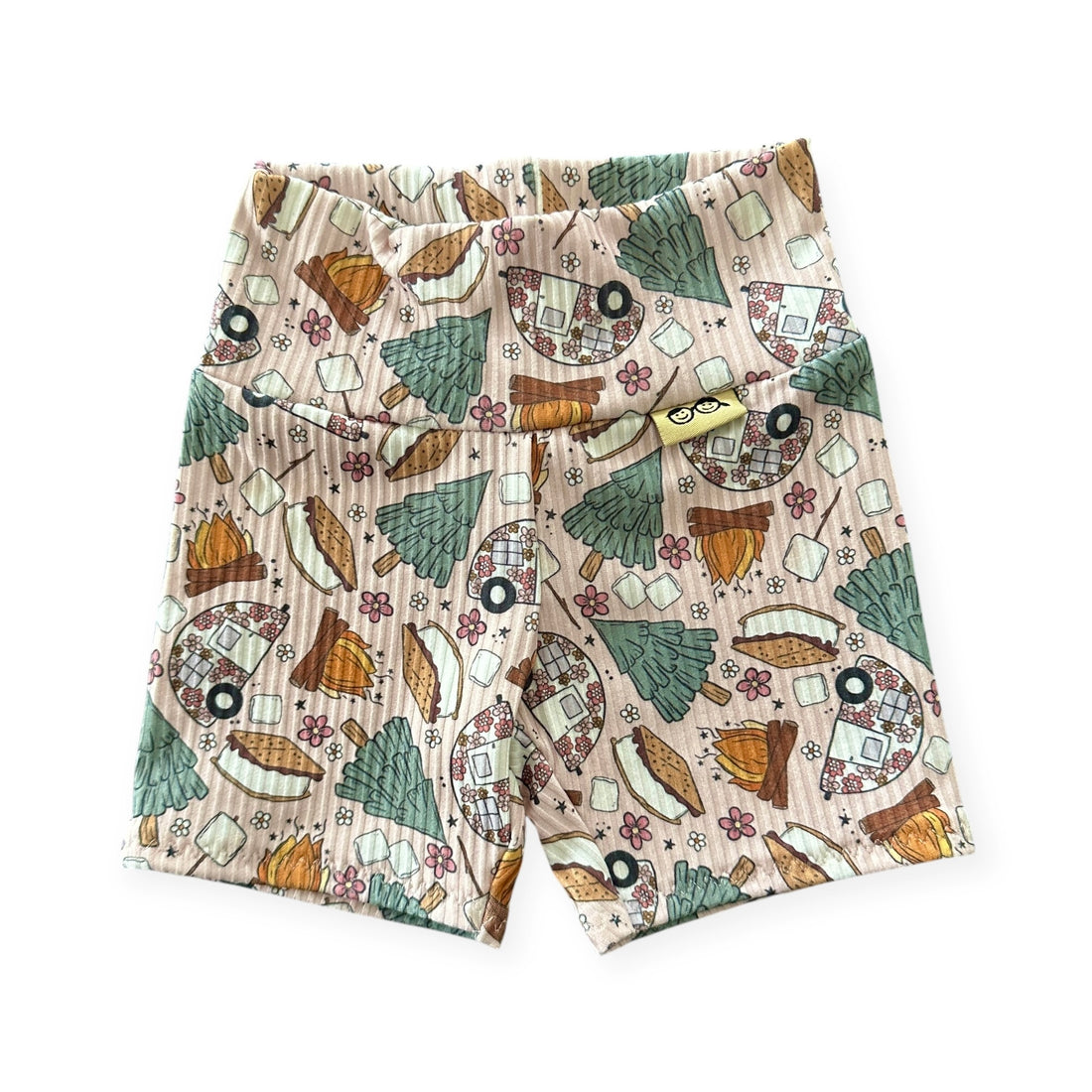Baby biker shorts in cozy camping print with trees and s’mores.