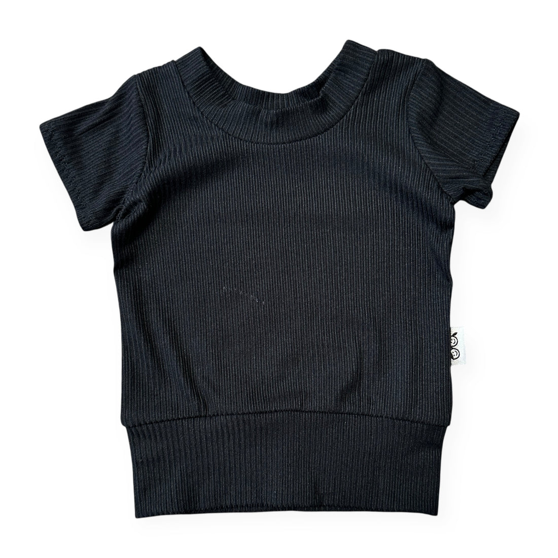 Black ribbed baby sweater with short sleeves on a white background