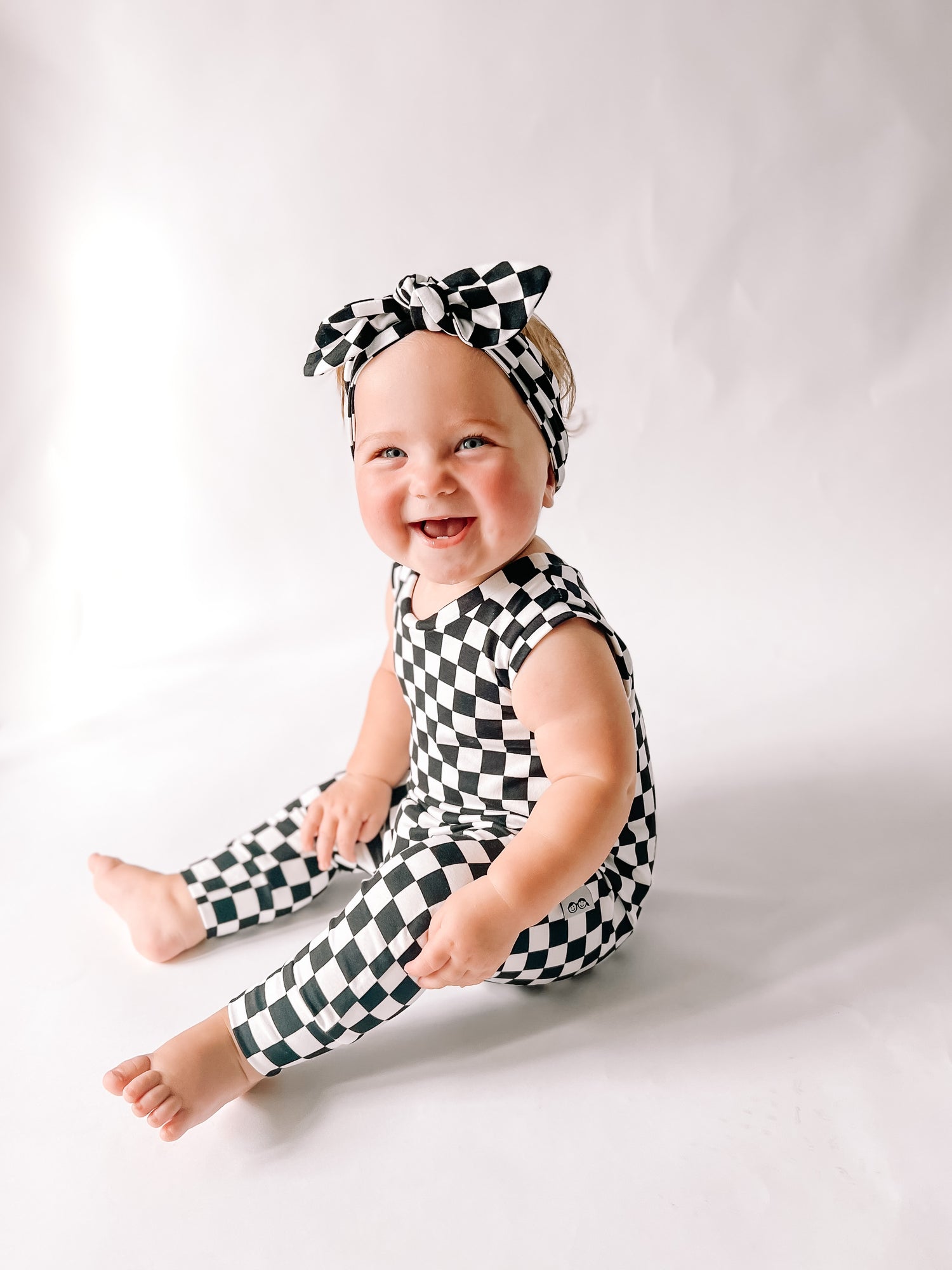 Baby Girl in Black Retro Checkered Harem Romper