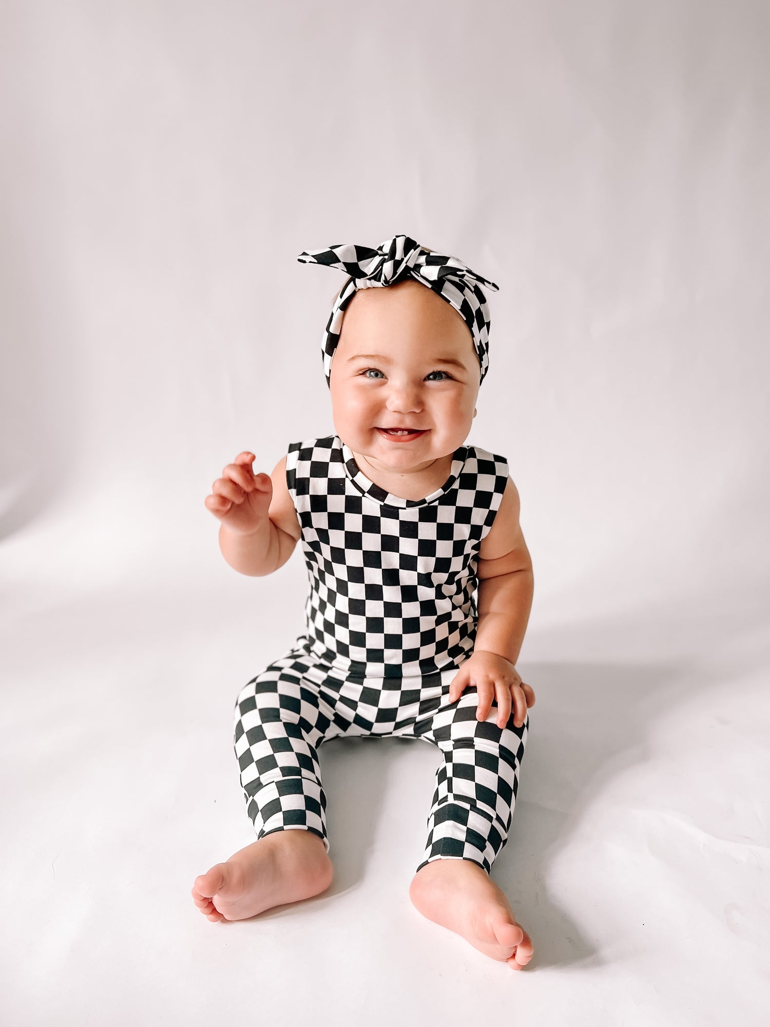 Baby Girl in Black Retro Checkered Harem Romper