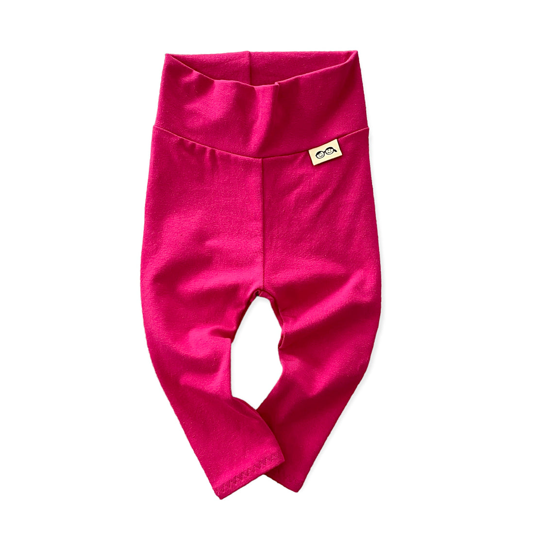 Handmade hot pink baby leggings with a fold-over waistband, displayed flat on a white background. Soft and stretchy for a perfect fit, these gender-neutral baby pants are great for layering with onesies, sweaters, and tees. Available in sizes preemie to 4T.